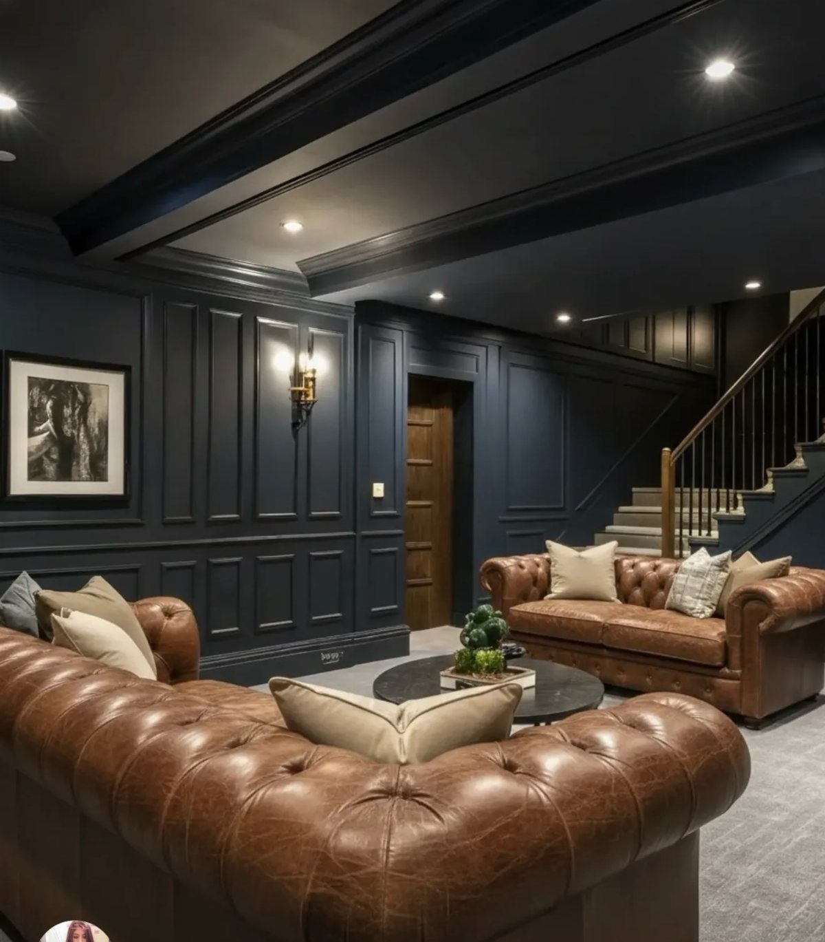 Dark navy blue walls and ceiling with leather sofas in a modern living room.
