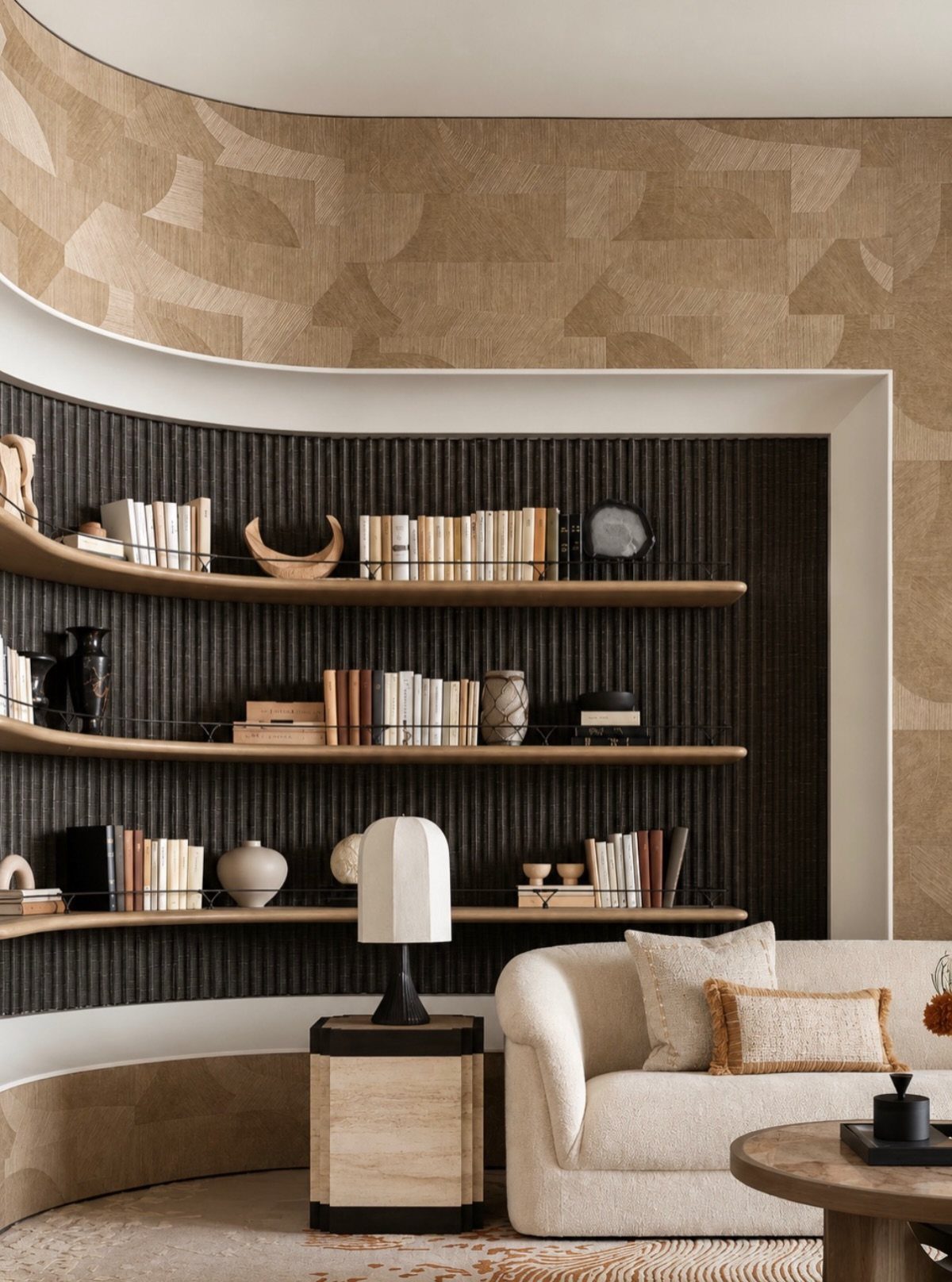 Curved wooden shelves filled with books and decor against a dark ribbed wall.