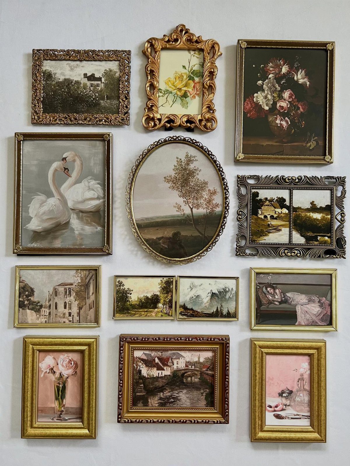 Assorted vintage framed paintings and ornate gold frames arranged in a gallery wall layout.
