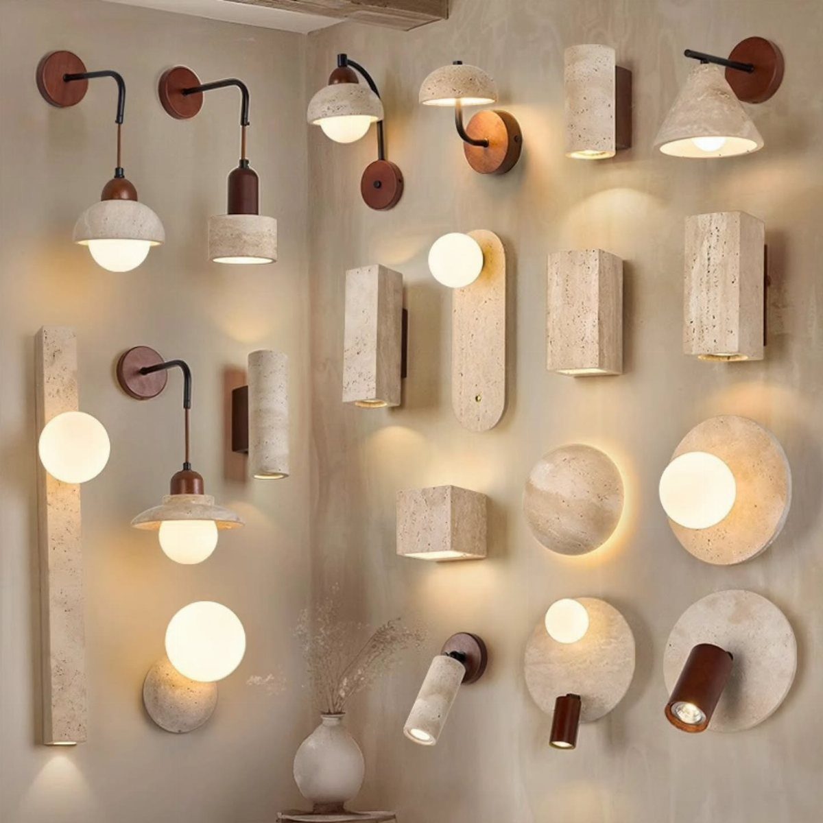 Various modern wall sconces in stone and metal glowing against a beige textured wall.