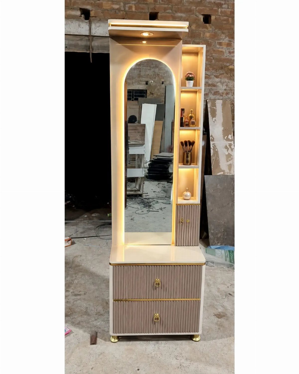 Cream dressing table with an arched lighted mirror and integrated side shelving units.
