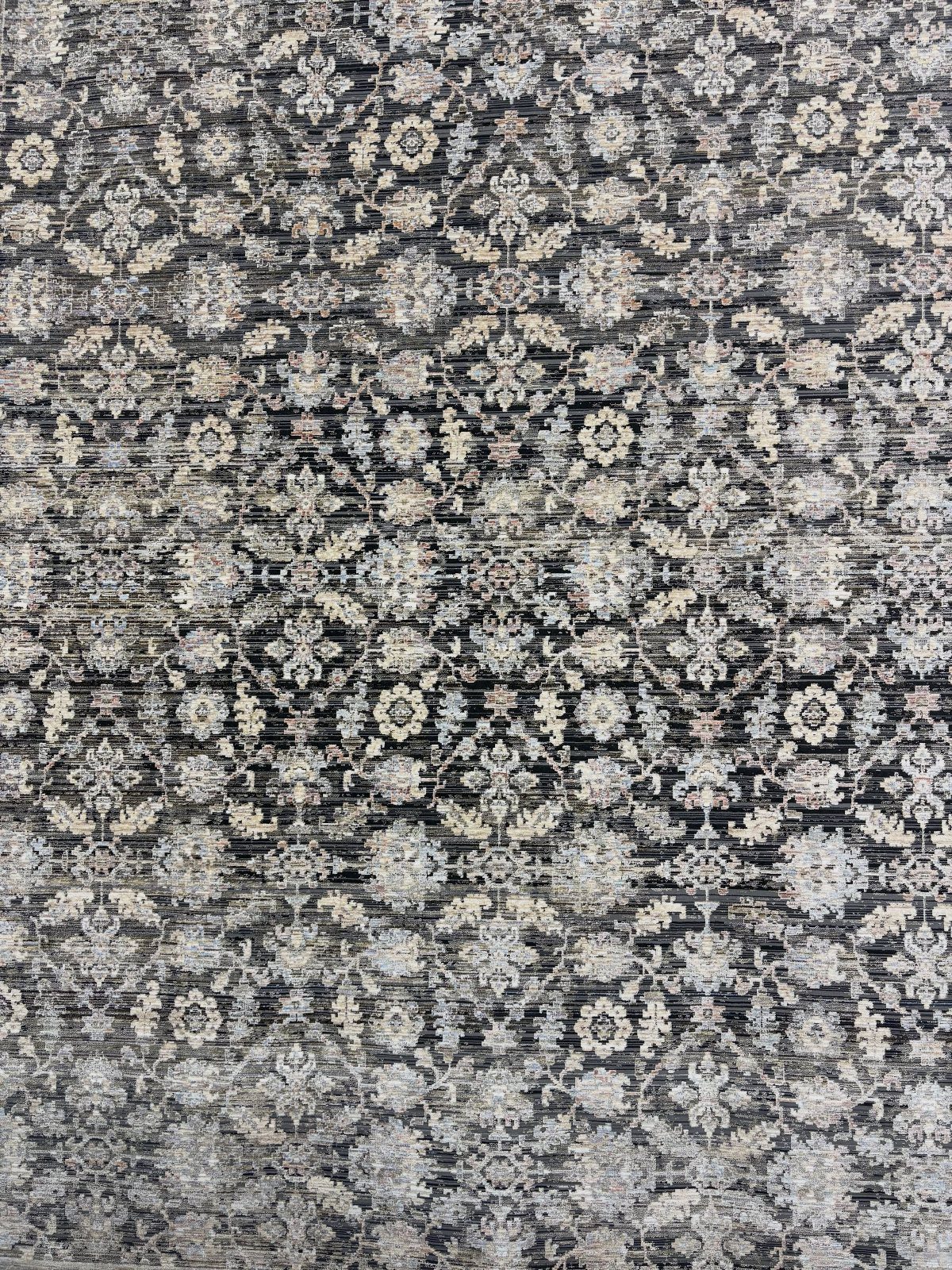 Intricate grey and cream floral patterned rug with a soft woven texture.