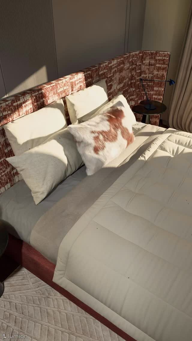 A bed with white linens, white pillows, and a patterned faux fur pillow against a textured headboard.