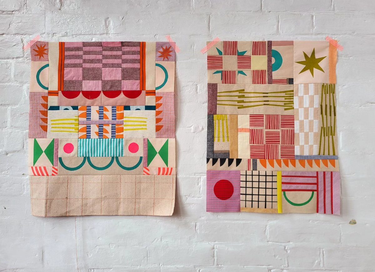 Two colorful geometric patchwork fabric hangings hanging on a white brick wall.