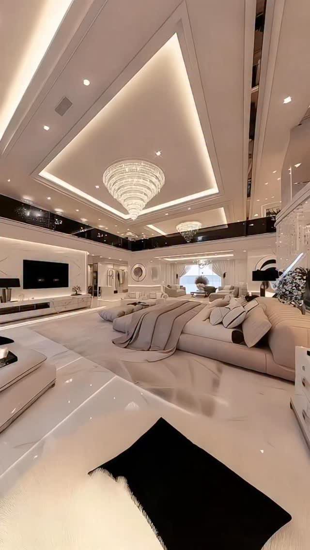 Luxurious modern bedroom with glossy white floors, a large beige sofa, and a crystal chandelier.