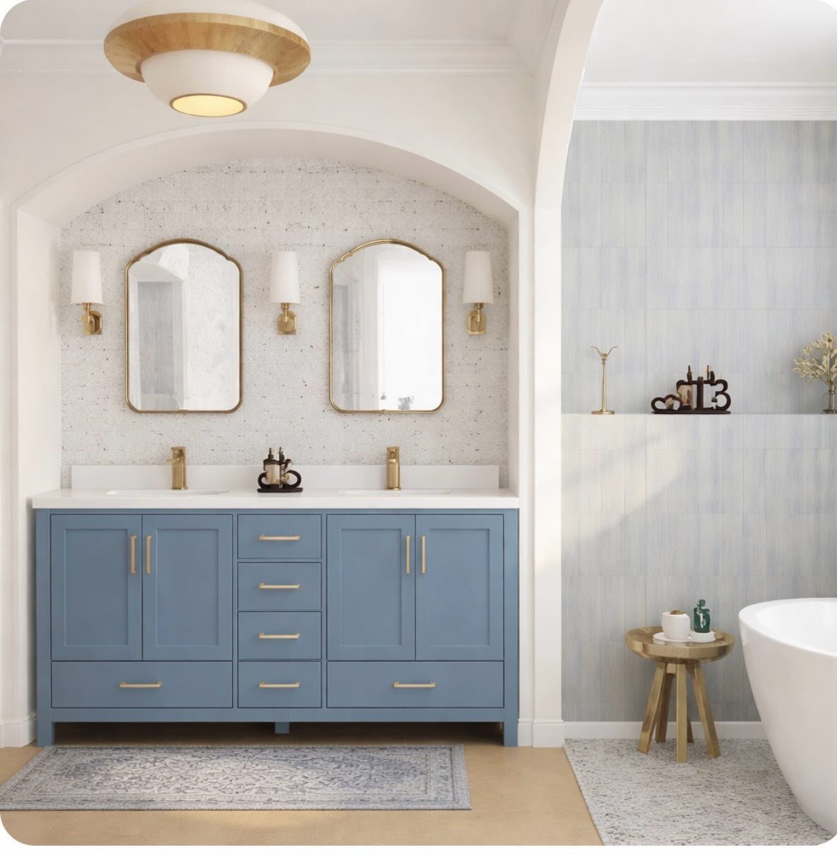 A blue double vanity with gold hardware positioned under a white arched alcove.