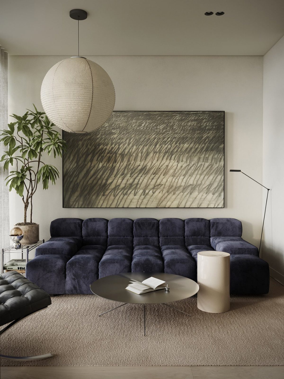 A navy blue modular sofa sits in a modern room with a large abstract painting and paper pendant light.