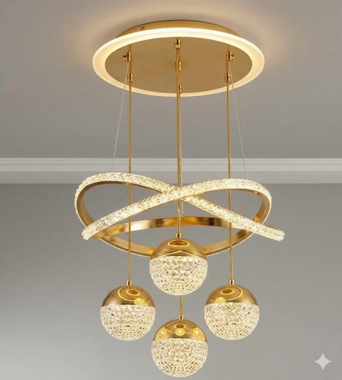A modern gold and crystal chandelier with spherical pendants hanging from a ceiling.
