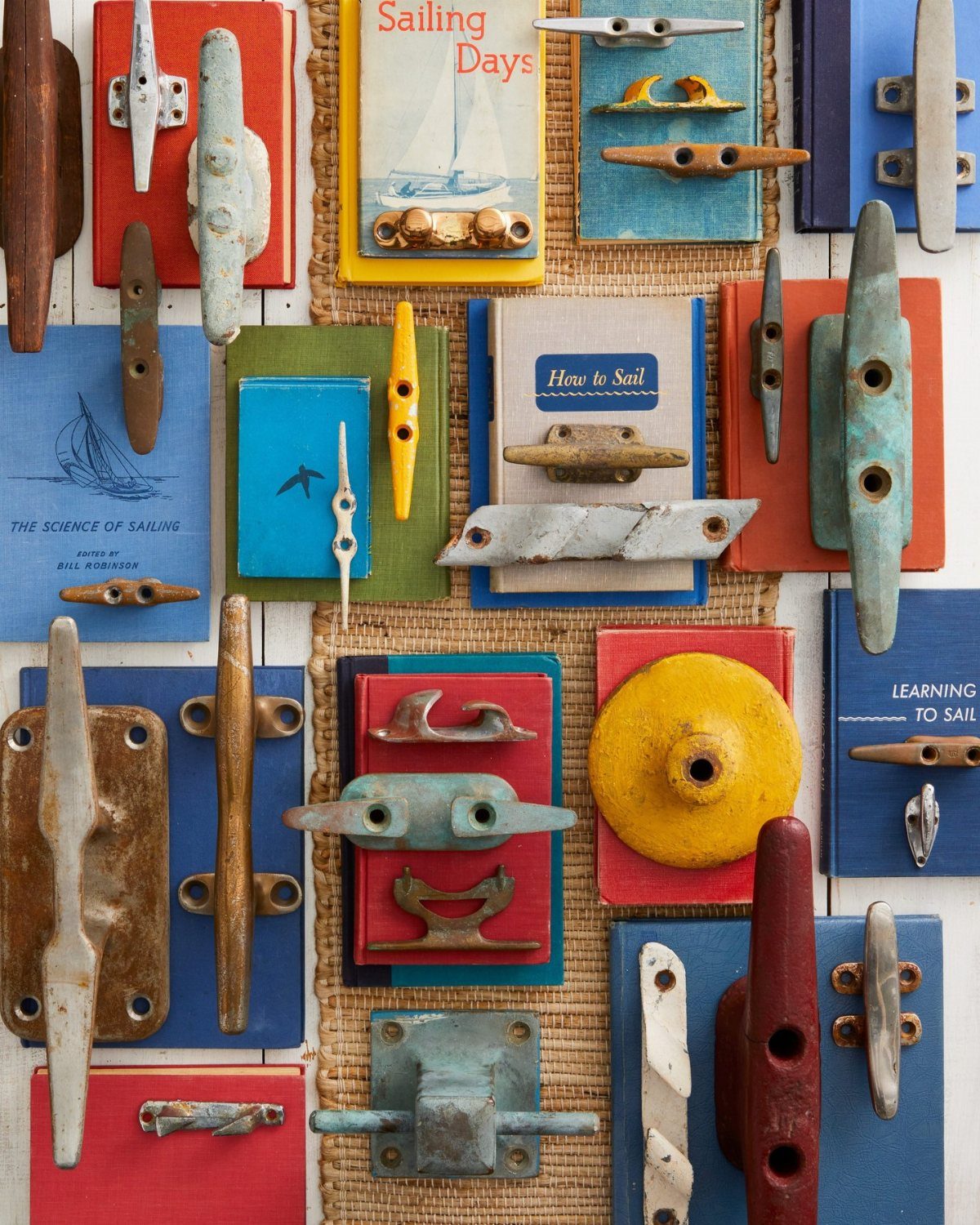Colorful weathered nautical cleats mounted on various painted wooden boards.