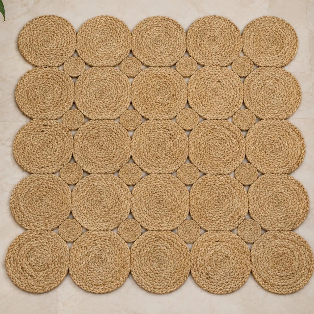 A textured natural fiber rug made of interconnected circular woven jute discs on a light floor.
