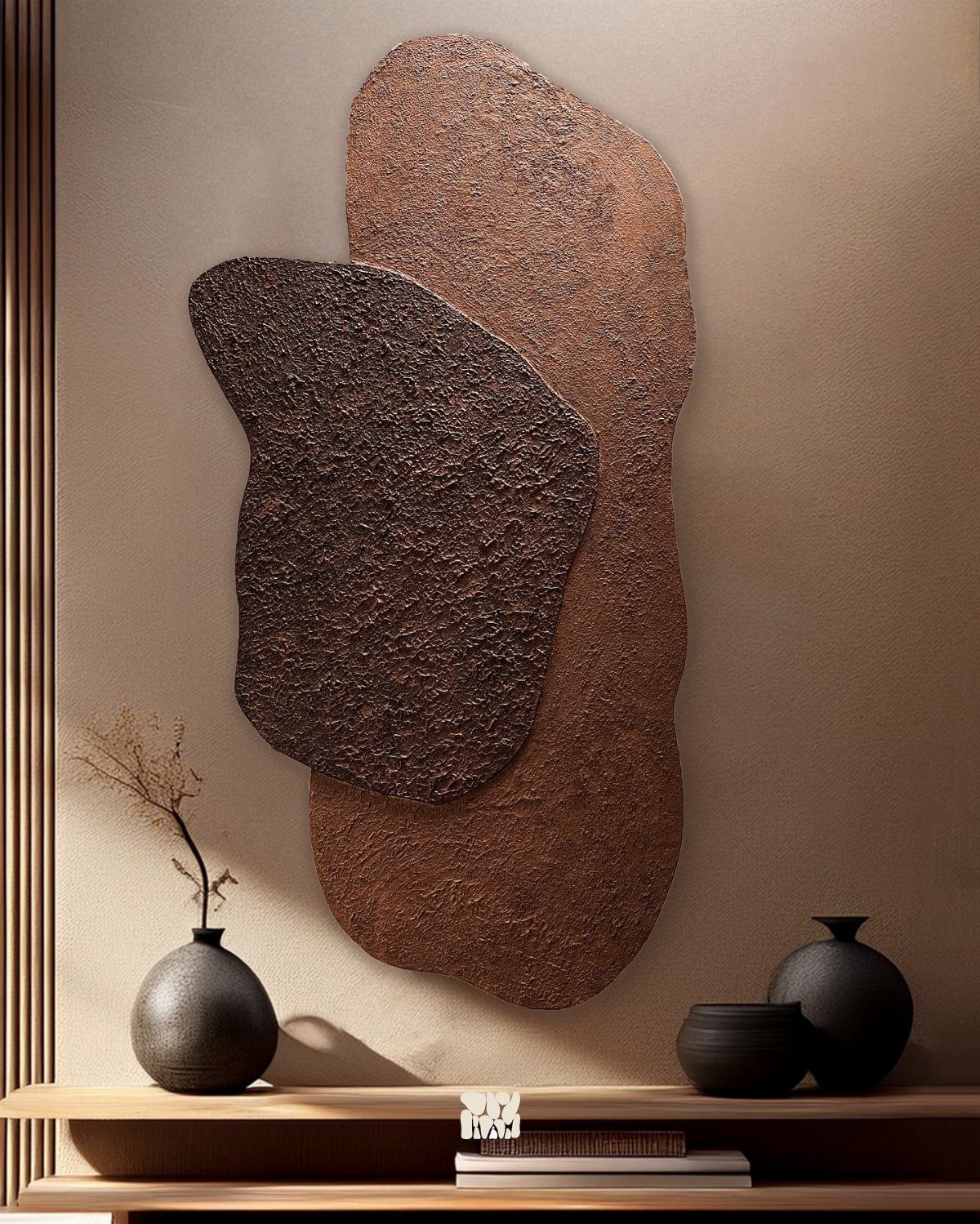 Textured organic wall art in brown and terracotta hanging above a wooden shelf with black vases.