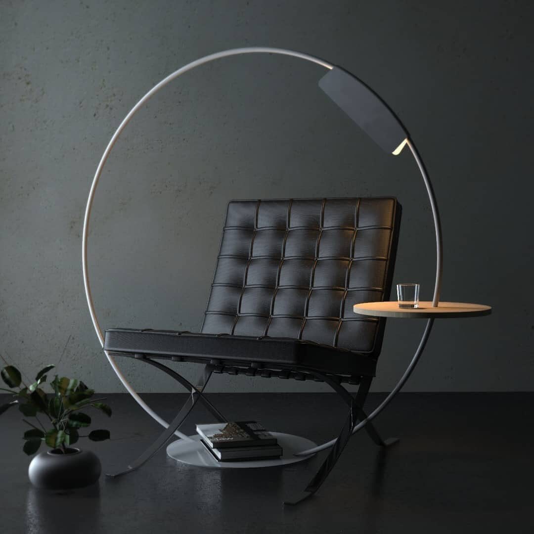 Black leather lounge chair inside a large white circular metal frame with an integrated side table.