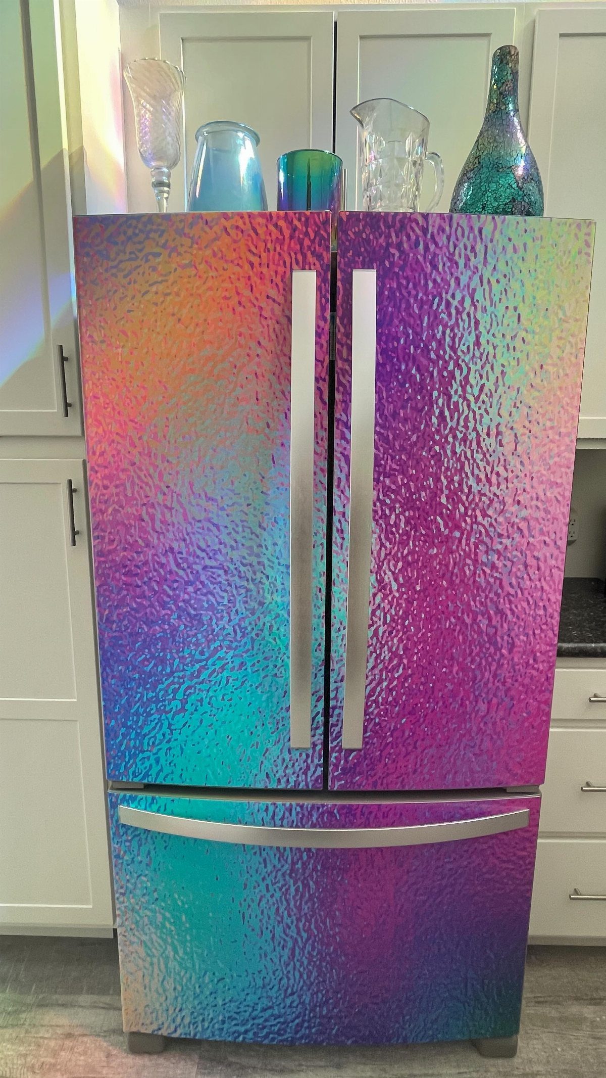 Iridescent holographic textured wrap covering a large stainless steel French door refrigerator.