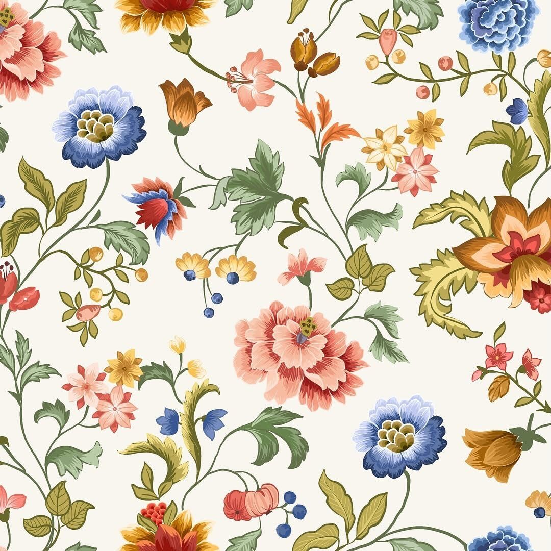 Colorful floral pattern with red, blue, and yellow flowers on a cream background.