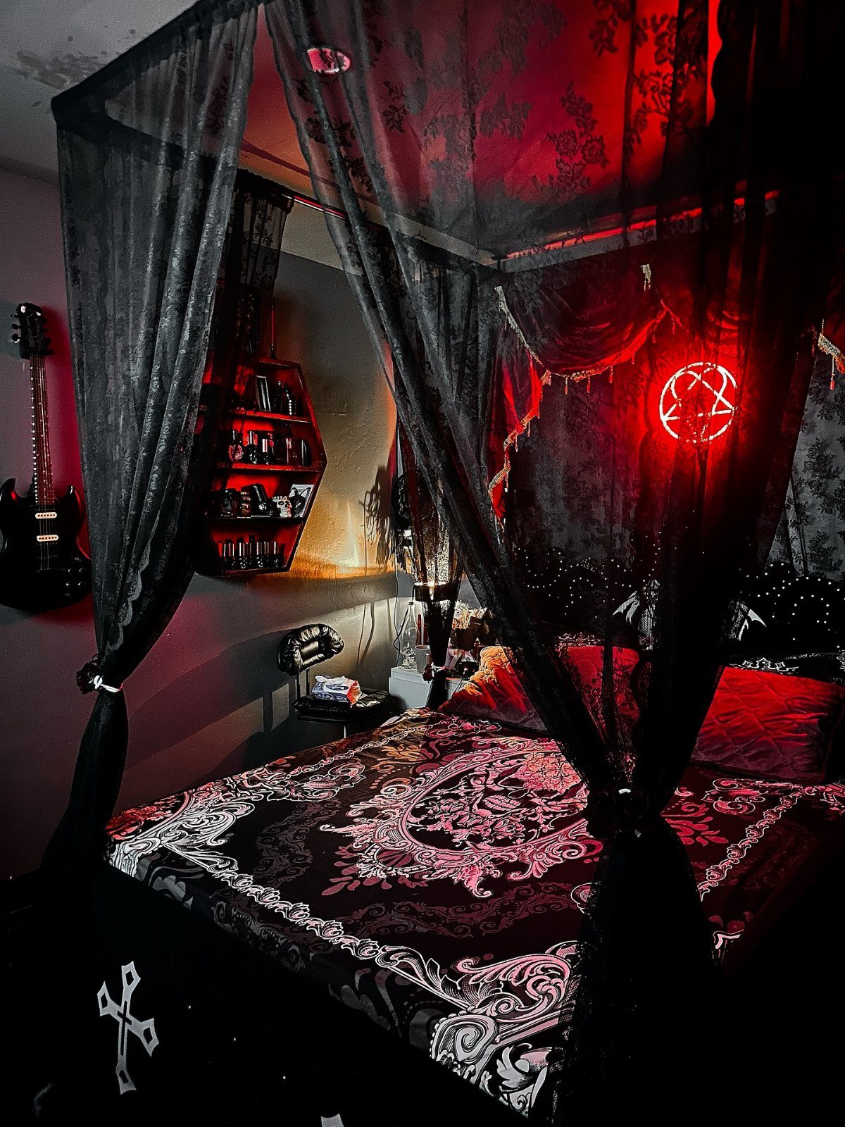 Gothic bedroom with a canopy bed, red neon pentagram, and black electric guitar.
