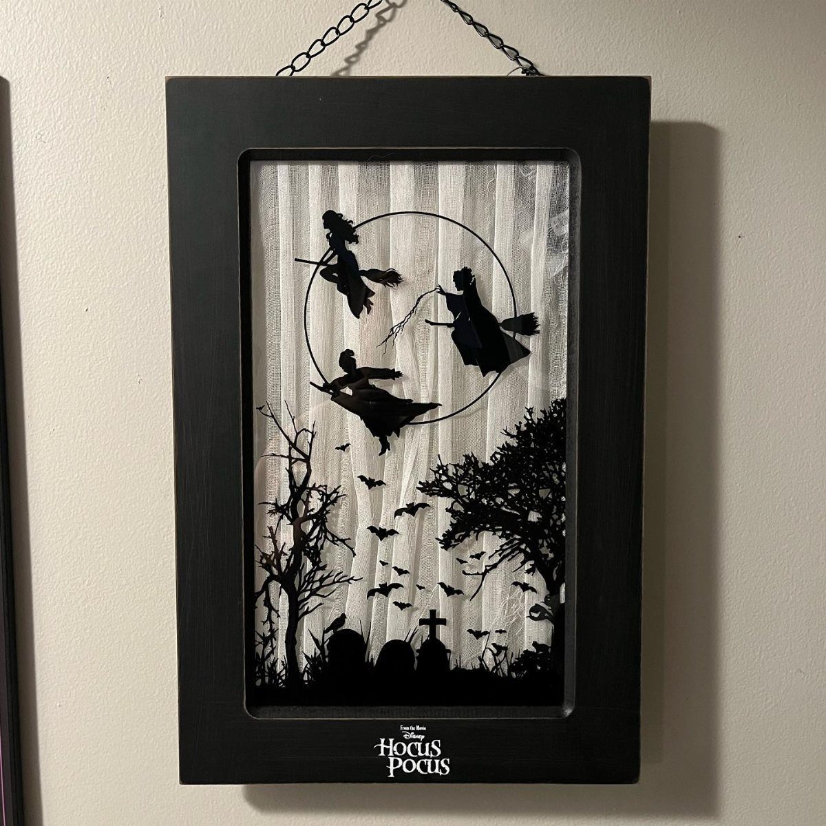Black Hocus Pocus shadow box art featuring silhouettes of witches flying over a graveyard.