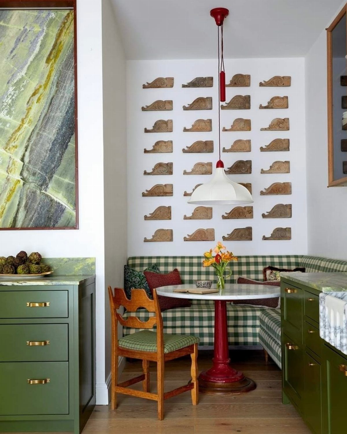 Small wooden floating shelves arranged in rows on a white wall above a breakfast nook.