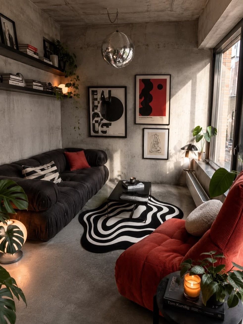 Concrete walls and floors in a modern living room with colorful furniture and abstract art.
