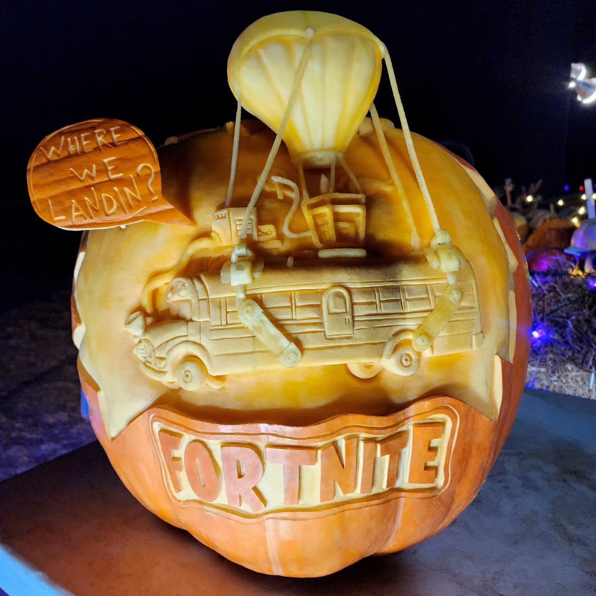 Carved Fortnite pumpkin featuring the Battle Bus, a parachute, and a speech bubble.