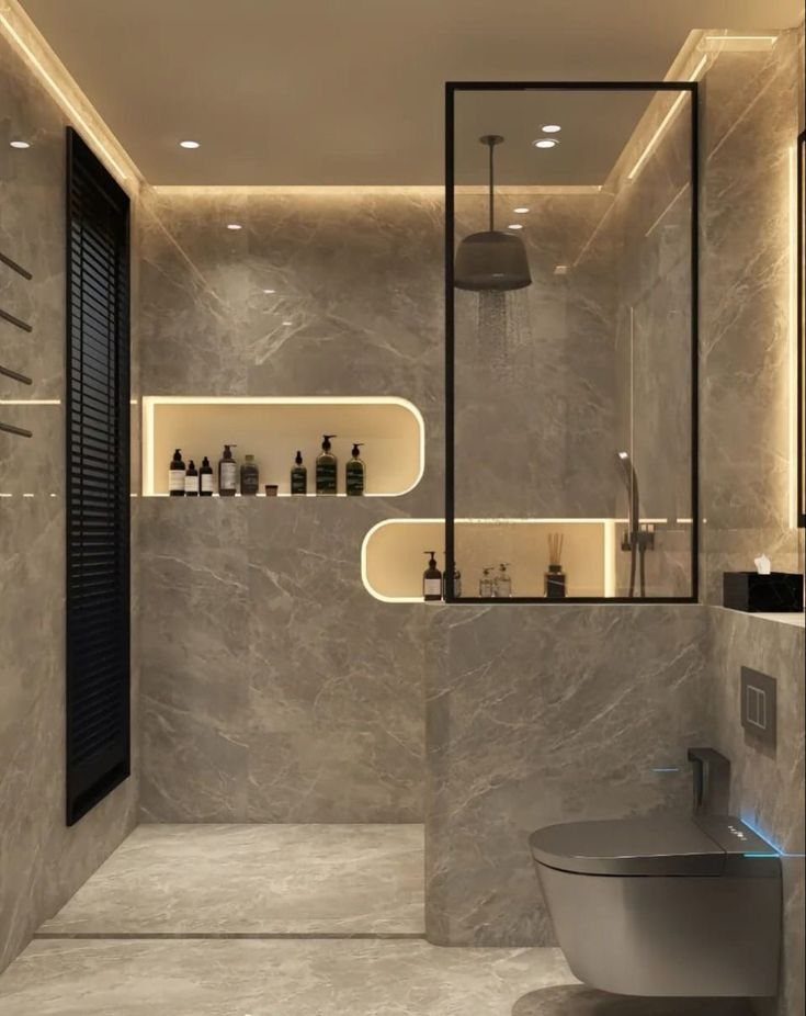 Modern marble bathroom featuring warm recessed shelf lighting and a glass shower enclosure.