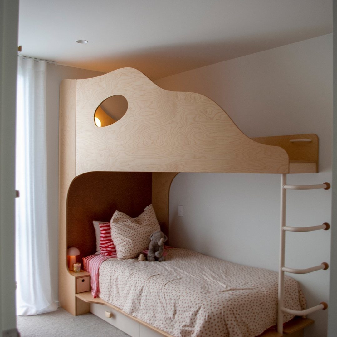 Light wood bunk bed with built-in storage drawers and patterned bedding in a bright room.