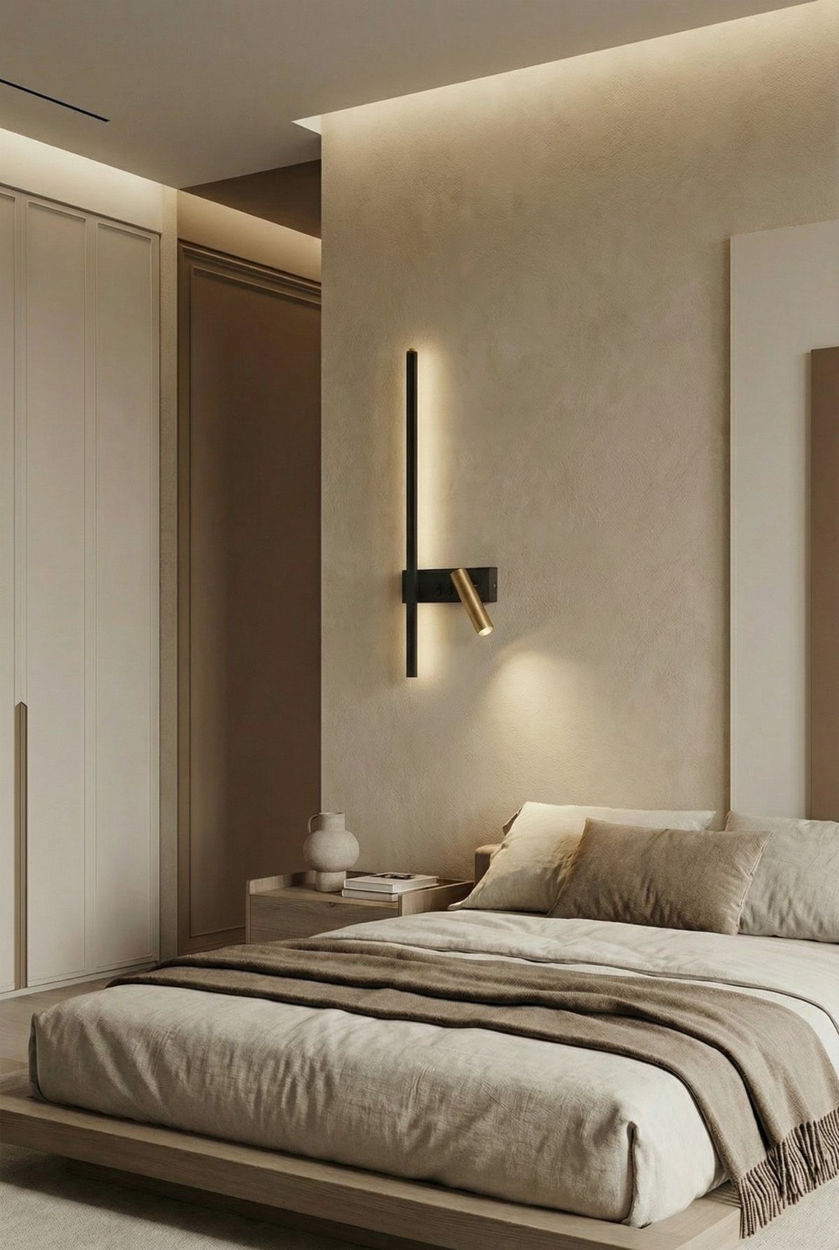 Modern black linear wall light and adjustable gold spotlight mounted above a neutral-toned bed.