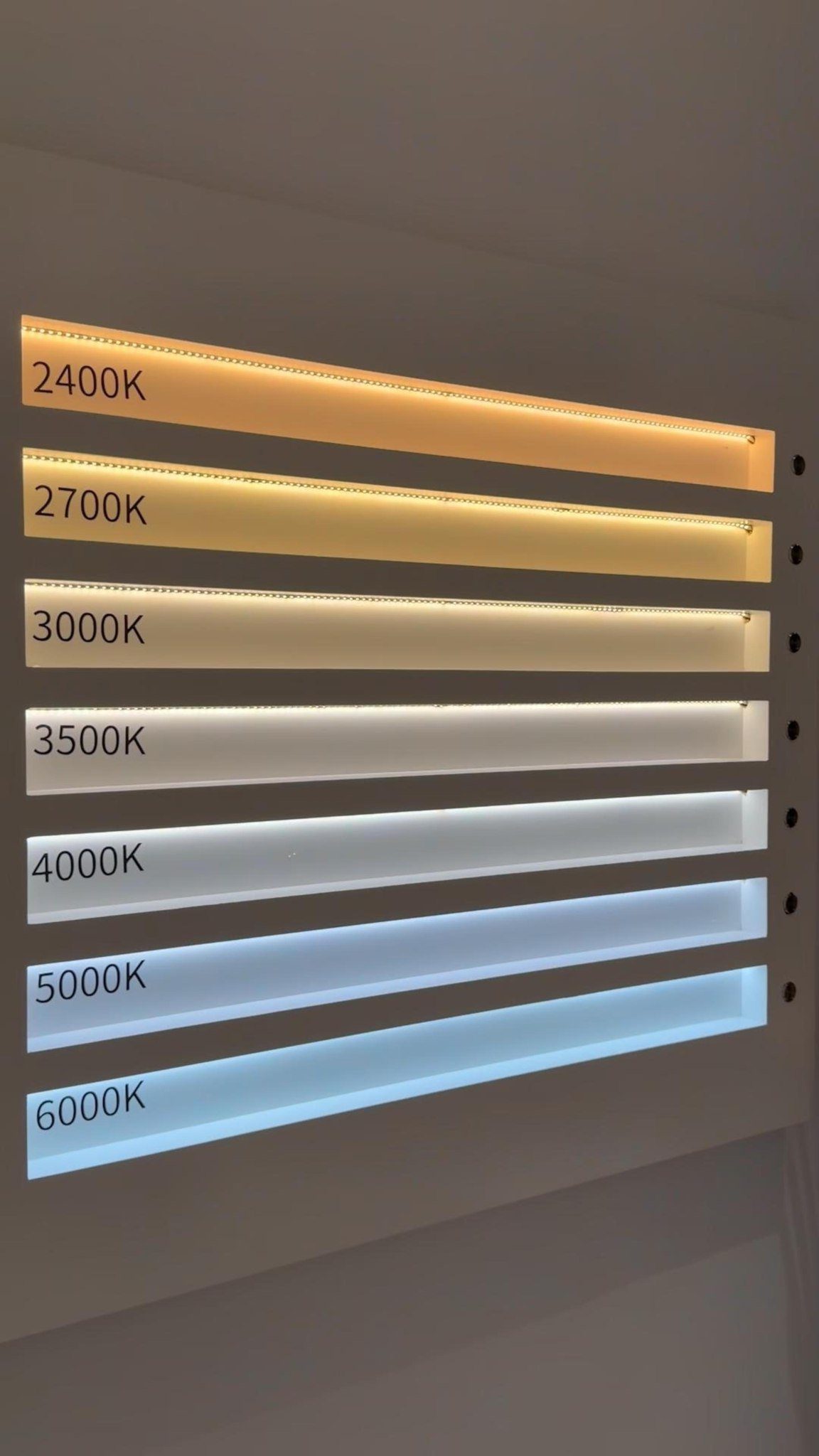 Seven light strips displaying a color temperature gradient from warm orange to cool blue.