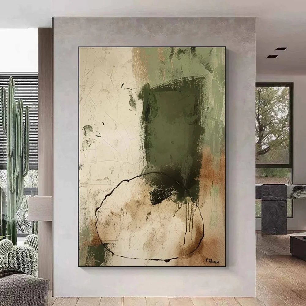 Large abstract painting with green and beige tones hanging on a grey wall.