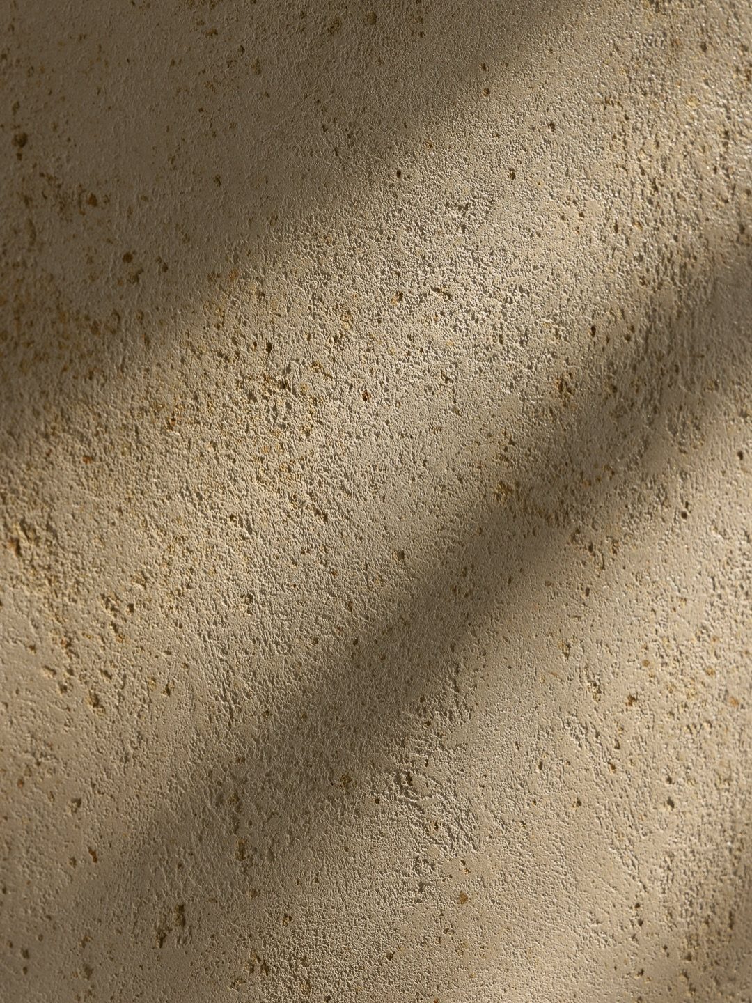 Beige textured wall surface with diagonal shadows falling across the grainy material.