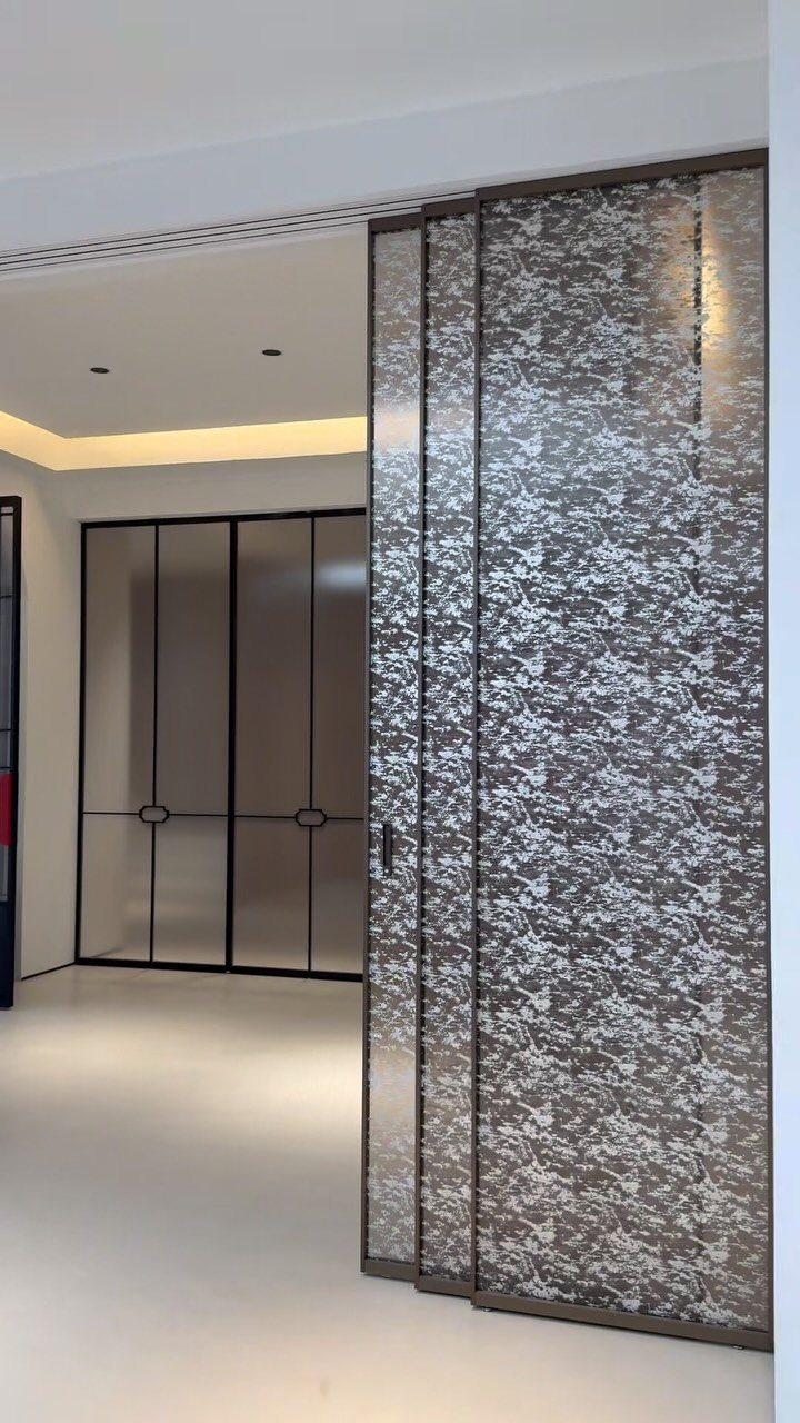 Large textured grey and white sliding panels acting as a minimalist room divider.