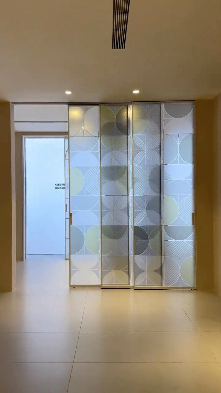 Four patterned sliding door panels in a modern room with neutral tones.