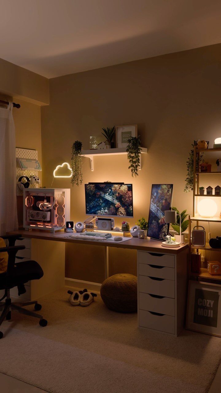 A desk setup illuminated by warm ambient lighting, a neon cloud, and a glowing computer.