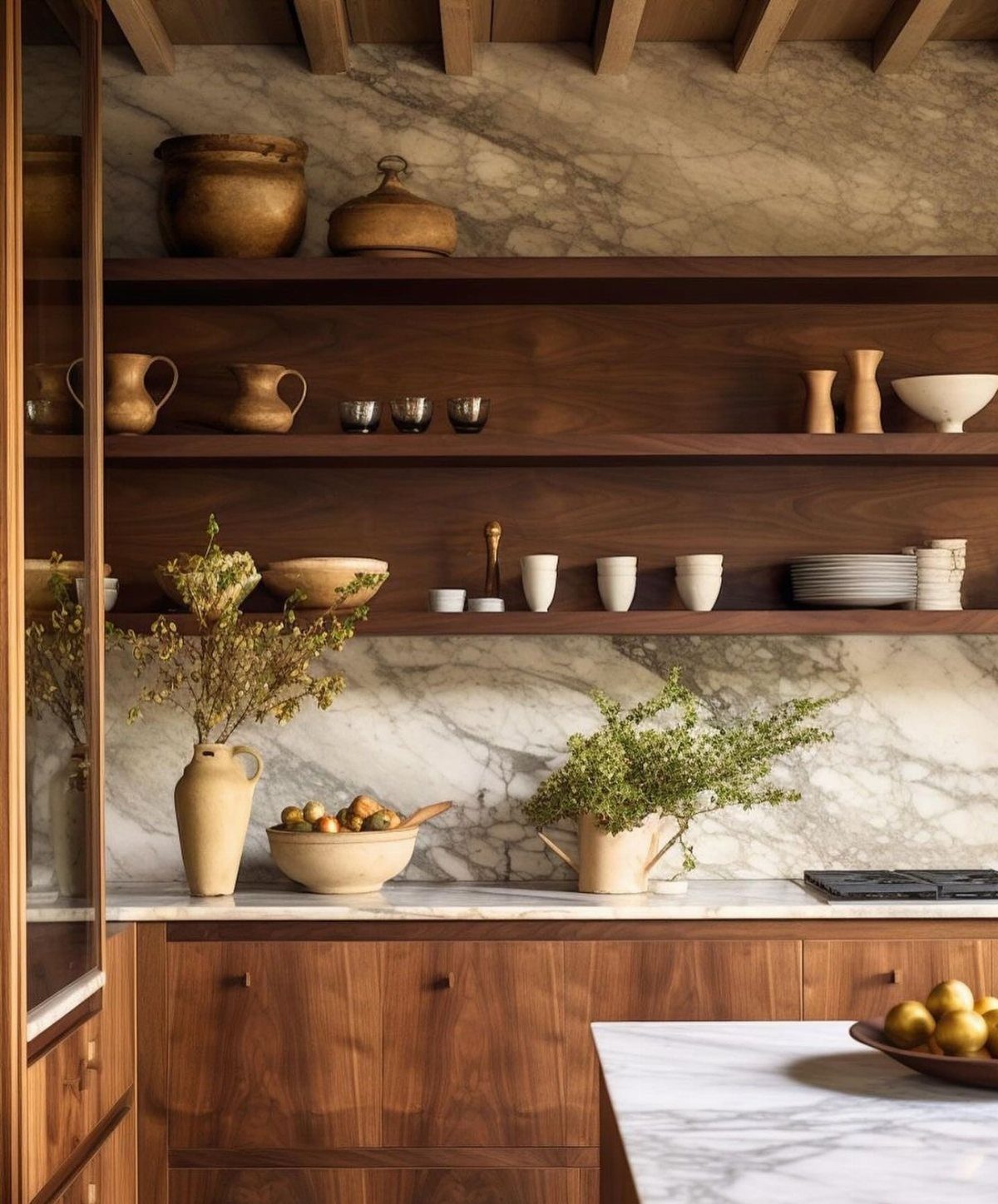 Dark wood open shelves displaying various ceramic pottery and bowls against a marble wall.
