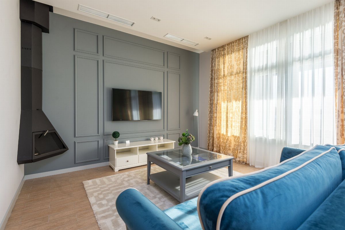 Dark grey paneled accent wall with a mounted television in a modern living room.