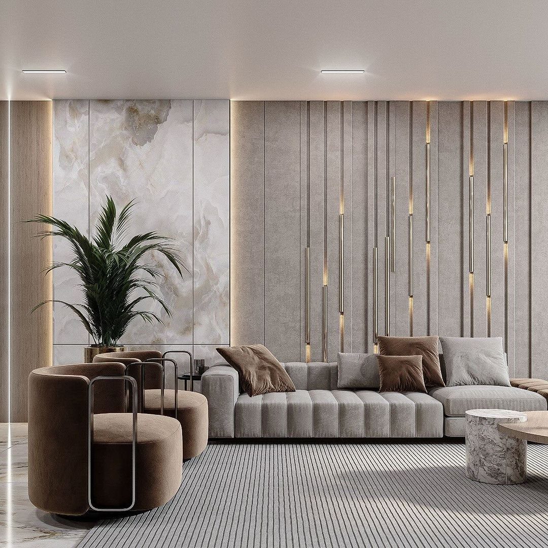 Grey ribbed sofa and brown velvet armchairs in a modern living room with textured walls.
