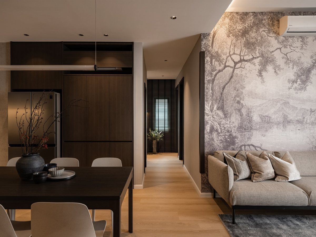 Grey landscape patterned wallpaper behind a light grey sofa in a modern living room.