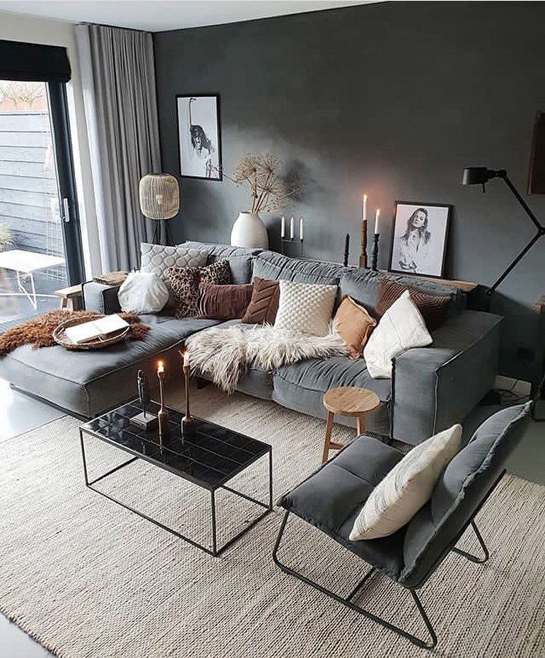 Grey sectional sofa with many textured pillows and a soft faux-fur throw blanket.