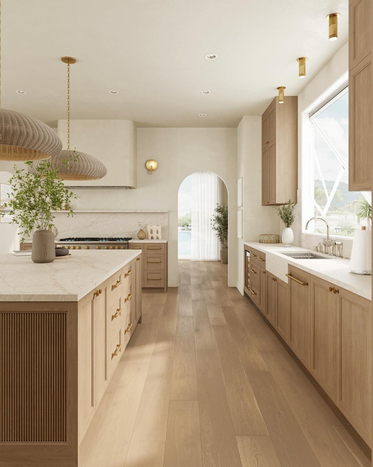 Modern kitchen with light wood cabinets, marble island, and wooden floors in a bright room.