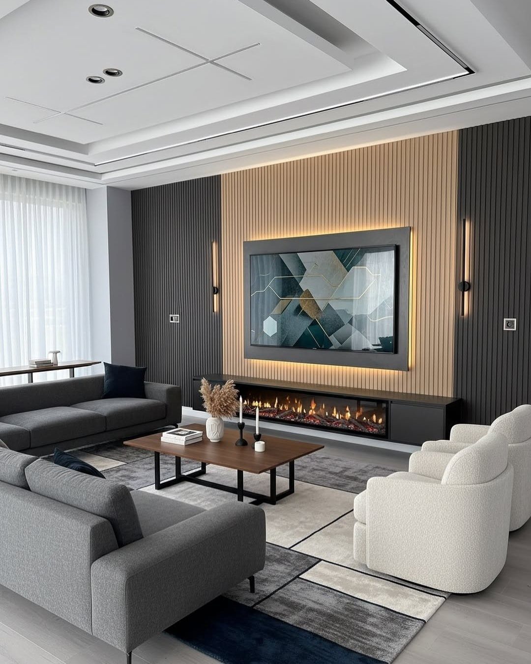 Modern living room with a wood slatted wall, large TV, fireplace, and grey and white furniture.