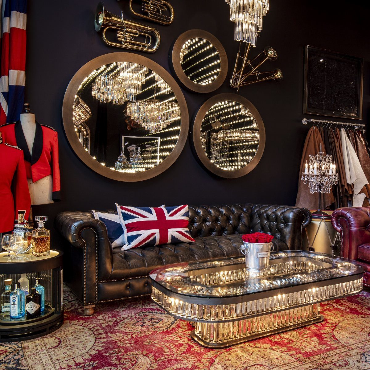 A crystal and glass coffee table in a dark, luxurious Victorian style living room.