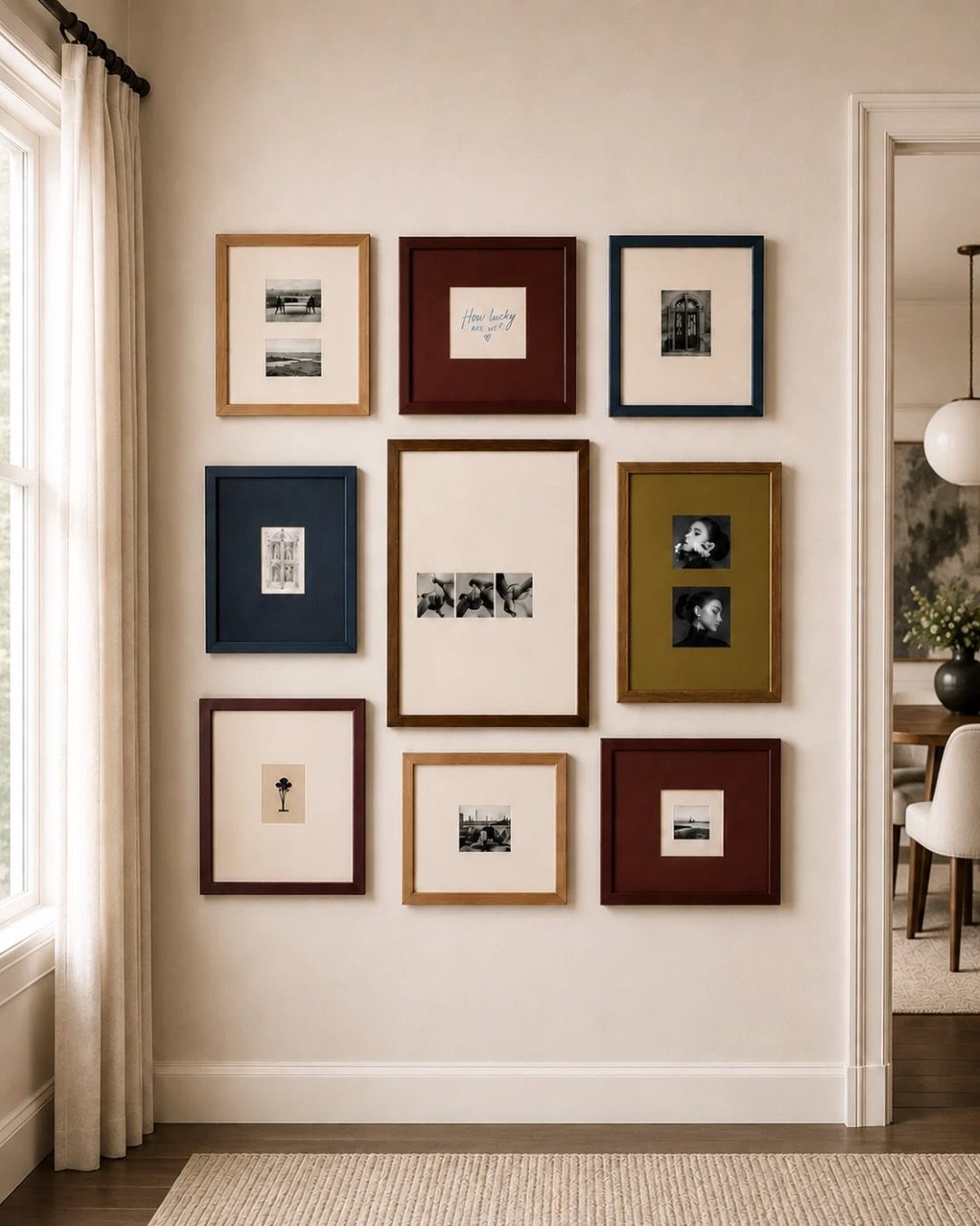 Nine assorted framed art pieces arranged in a grid on a neutral wall.