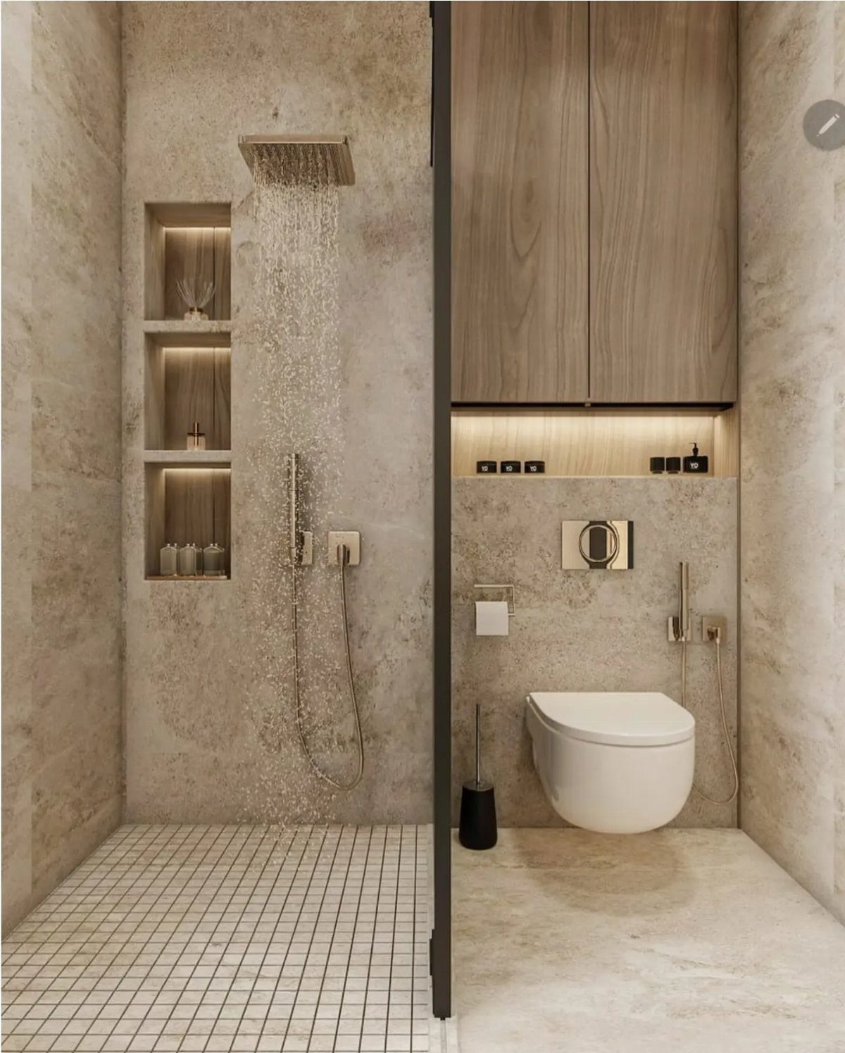 Rainfall showerhead pouring water against textured stone walls in a modern bathroom.