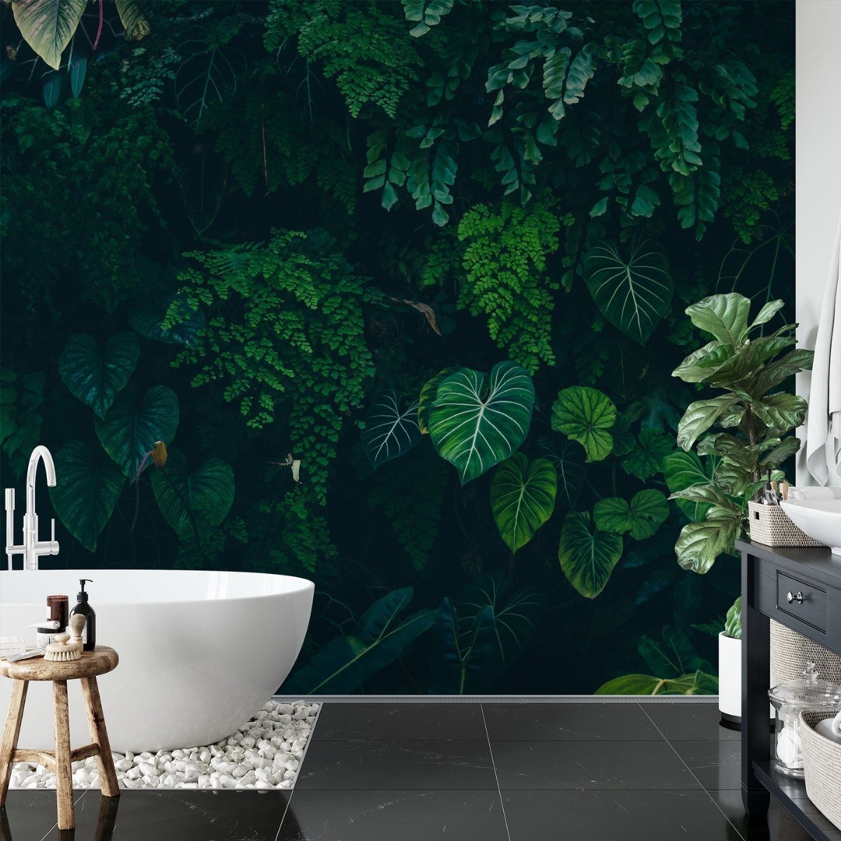 White freestanding bathtub positioned against a lush dark green tropical leaf wallpaper.