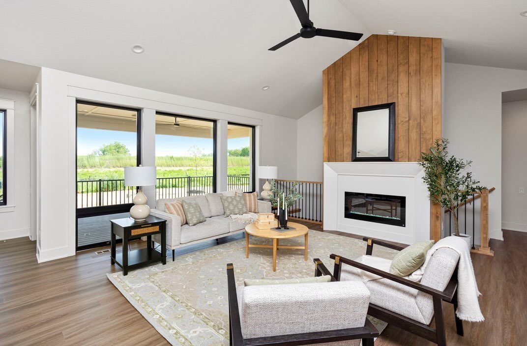 Modern living room with large glass doors letting in bright natural light and wooden accents.