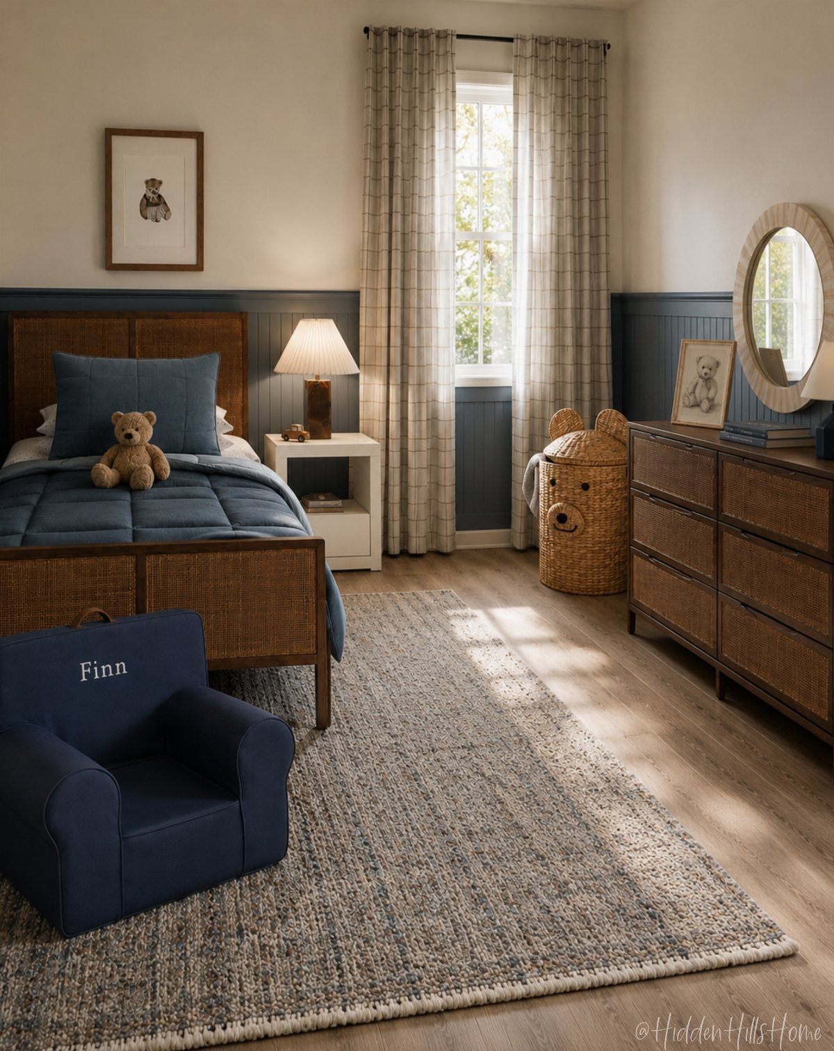 A child's bedroom with navy blue bedding, a rattan bed frame, and a small navy blue armchair.