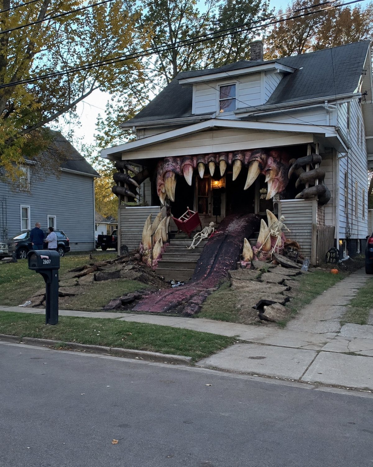 A house decorated with a large monster mouth, teeth, and a long red tongue.