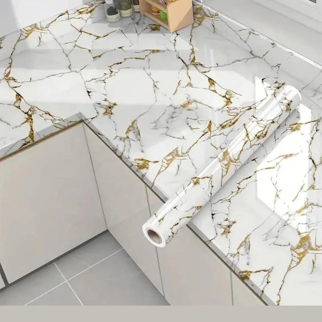 Marble patterned contact paper roll on a matching marble-effect kitchen countertop.