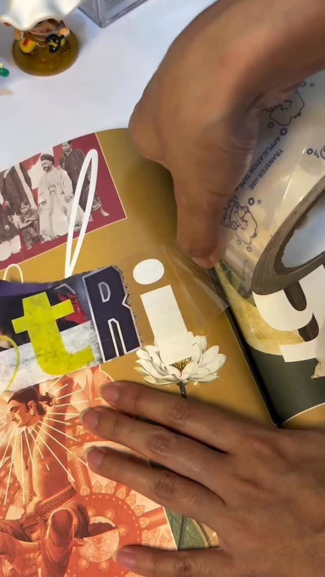 Hands applying clear tape to magazine cutouts for a DIY craft project.