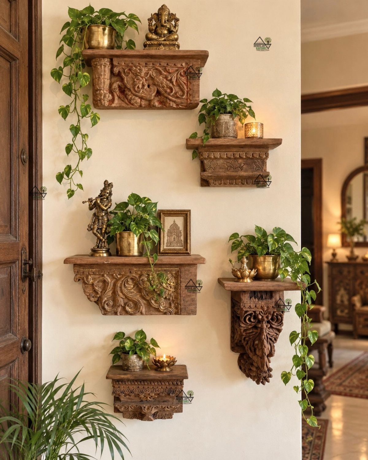 Carved wooden wall shelves holding green plants, brass statues, and glowing candles against a cream wall.