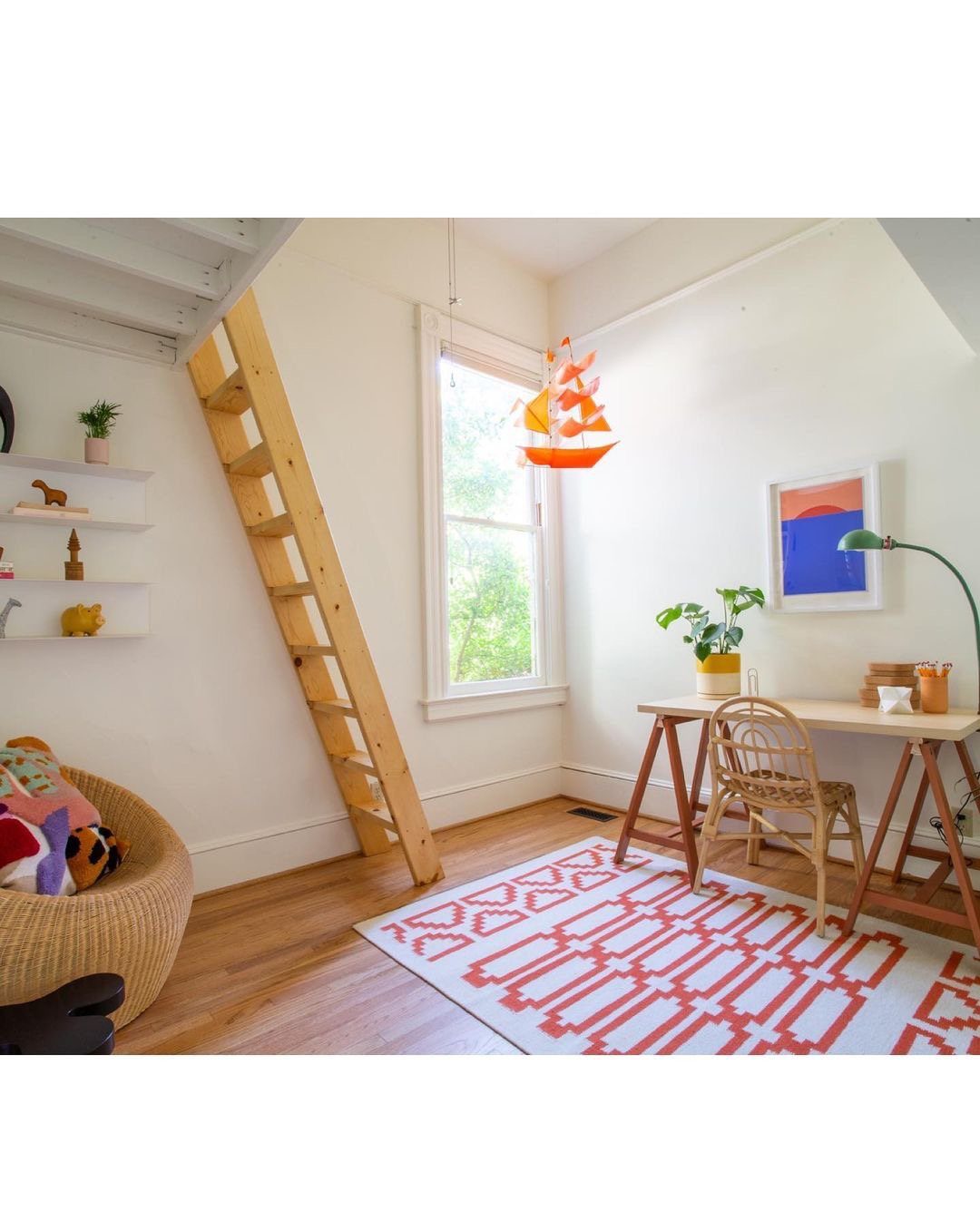 Wooden ladder leaning against a white wall leading to a lofted sleeping area.